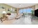 Relaxing living room showcasing a comfy white sectional, tile flooring, and balcony access at 4 Oceans West Blvd # 502B, Daytona Beach, FL 32118