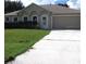 Well-kept one-story home with an attached two-car garage and concrete driveway at 1118 Perpignan Ct, Kissimmee, FL 34759