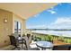 Relaxing balcony with outdoor seating and a picturesque lake view at 8749 The Esplanade # 6, Orlando, FL 32836