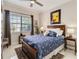 Cozy bedroom with a large window, ceiling fan, and en-suite bathroom at 8749 The Esplanade # 6, Orlando, FL 32836