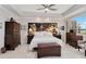 Spacious primary bedroom with tray ceilings, large windows, and elegant furnishings at 8749 The Esplanade # 6, Orlando, FL 32836
