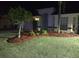 Charming single-story home featuring a well-manicured lawn and mature landscaping at night at 15824 Green Cove Blvd, Clermont, FL 34714