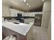 Modern kitchen with white cabinets, stainless steel appliances, and bright countertops at 15824 Green Cove Blvd, Clermont, FL 34714