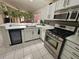 Modern kitchen features stainless steel appliances, granite countertops, white cabinets, and lots of natural light at 15824 Green Cove Blvd, Clermont, FL 34714