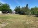 Large open backyard with green grass, a shed, and plenty of space for outdoor enjoyment at 311 James Ave, Auburndale, FL 33823