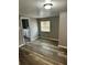 Bedroom with new flooring, fresh paint and a glimpse into the adjacent bathroom at 311 James Ave, Auburndale, FL 33823