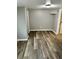 Clean bedroom with modern flooring, neutral paint, and a bright overhead light fixture at 311 James Ave, Auburndale, FL 33823