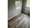 Bright room featuring a door, a window, and wood-look vinyl plank flooring at 311 James Ave, Auburndale, FL 33823