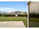 View of the backyard shows trimmed hedges, well manicured lawn, and brick paver patio at 8166 Sw 80Th Ter, Ocala, FL 34476