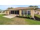 Backyard shows lush lawn, brick patio, and well-maintained landscaping at 8166 Sw 80Th Ter, Ocala, FL 34476