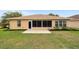 Backyard view showing lawn, patio and plantings at 8166 Sw 80Th Ter, Ocala, FL 34476