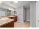 Bright bathroom featuring double sinks, wood cabinetry, neutral countertop, and tile flooring at 8166 Sw 80Th Ter, Ocala, FL 34476