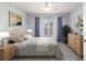 Comfortable bedroom with carpet, a large window providing natural light, and neutral tones for a relaxing atmosphere at 8166 Sw 80Th Ter, Ocala, FL 34476