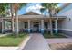 Exterior view of the community center with a brick walkway, lush landscaping, and ample seating for residents and guests at 8166 Sw 80Th Ter, Ocala, FL 34476