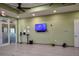 A well-equipped gym boasts a wall-mounted TV, hand sanitizing station, and various fitness tools for a complete workout at 8166 Sw 80Th Ter, Ocala, FL 34476