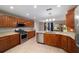 Bright kitchen features wood cabinets, stainless steel appliances, and a central island with granite countertops at 8166 Sw 80Th Ter, Ocala, FL 34476