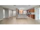 Open kitchen and living area with stainless steel appliances, granite countertops, and a breakfast bar at 8166 Sw 80Th Ter, Ocala, FL 34476