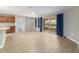 Open-concept living and kitchen area with light-toned floors and sliding glass doors to lanai at 8166 Sw 80Th Ter, Ocala, FL 34476