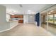 Open-concept living and kitchen area with light-toned floors and sliding glass doors to lanai at 8166 Sw 80Th Ter, Ocala, FL 34476