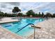 A community pool boasts a lap lane, clear blue water, and accessible steps for a refreshing swim and relaxation at 8166 Sw 80Th Ter, Ocala, FL 34476