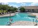 Community pool with ample lounge seating, umbrellas for shade, and a relaxing environment for residents and guests at 8166 Sw 80Th Ter, Ocala, FL 34476