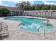 Large community pool with seating, lounge chairs, umbrellas and surrounding lush landscaping creating a relaxing environment at 8166 Sw 80Th Ter, Ocala, FL 34476