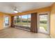 Bright sunroom boasts wood floors, neutral walls, ceiling fan and access to back yard at 8166 Sw 80Th Ter, Ocala, FL 34476