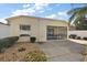 Rear exterior showcasing a screened patio and nicely landscaped yard at 1787 Foliage Ln, The Villages, FL 32162