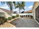 Private backyard featuring mature landscaping, concrete patio, rock garden, and a privacy fence at 1787 Foliage Ln, The Villages, FL 32162