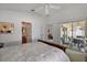 Bright bedroom featuring a sliding glass door to the patio and a ceiling fan at 1787 Foliage Ln, The Villages, FL 32162