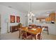 Bright dining area open to the kitchen, featuring a chandelier and ample seating space at 1787 Foliage Ln, The Villages, FL 32162