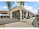 Outdoor patio with a screened-in porch with furniture and a grill at 1787 Foliage Ln, The Villages, FL 32162