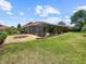 Sprawling backyard with manicured lawn and a screened-in pool at 6567 Eagle Ridge Way, Lakeland, FL 33813