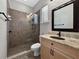 Modern bathroom with glass-enclosed shower, vanity with granite countertop, and tiled floors at 6567 Eagle Ridge Way, Lakeland, FL 33813