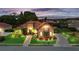 Stunning home exterior with lush landscaping, and a paver driveway at 6567 Eagle Ridge Way, Lakeland, FL 33813