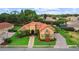 Stunning house featuring a red tile roof, stucco exterior, mature landscaping, and a circular driveway at 6567 Eagle Ridge Way, Lakeland, FL 33813