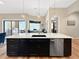 Kitchen island with modern sink, dishwasher, black cabinets, and pendant lighting at 6567 Eagle Ridge Way, Lakeland, FL 33813