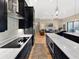 Modern kitchen with stainless steel appliances and marble countertops opens to a spacious living area at 6567 Eagle Ridge Way, Lakeland, FL 33813