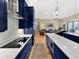 Kitchen featuring cooktop, white countertops, hardwood floors, and stainless steel appliances at 6567 Eagle Ridge Way, Lakeland, FL 33813