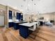 Bright, open kitchen featuring navy cabinets, marble countertops, and a view to the living room at 6567 Eagle Ridge Way, Lakeland, FL 33813