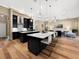 Open concept kitchen with a large island, pendant lighting, and hardwood floors at 6567 Eagle Ridge Way, Lakeland, FL 33813