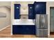 Kitchen featuring blue cabinets, a stainless steel refrigerator, and hardwood floors at 6567 Eagle Ridge Way, Lakeland, FL 33813