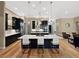 Open kitchen featuring a large island with barstool seating, black cabinetry, and stainless appliances at 6567 Eagle Ridge Way, Lakeland, FL 33813
