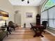 Cozy office area featuring hardwood flooring and abundant natural light with stylish furniture and neutral walls at 6567 Eagle Ridge Way, Lakeland, FL 33813