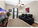 Living room with plush seating, ceiling fan, neutral walls, and wood floors at 6567 Eagle Ridge Way, Lakeland, FL 33813