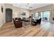Spacious living room with multiple seating areas, light-colored walls, and access to outdoor patio at 6567 Eagle Ridge Way, Lakeland, FL 33813