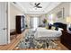 Comfortable main bedroom featuring tray ceilings, and soft natural light from large windows at 6567 Eagle Ridge Way, Lakeland, FL 33813