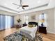 Inviting main bedroom with tray ceilings, a ceiling fan, and soft natural light at 6567 Eagle Ridge Way, Lakeland, FL 33813