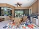 Covered outdoor patio with wicker furniture and a built-in barbecue grill at 6567 Eagle Ridge Way, Lakeland, FL 33813