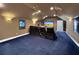 Home theater room featuring tiered seating and a large screen at 6567 Eagle Ridge Way, Lakeland, FL 33813